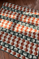 Full view of afghan laid on wooden floor.  thumbnail