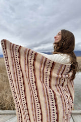 Back view of woman wearing afghan wrapped around shoulders.  thumbnail