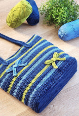 View of bottom of bag, showing flat bottom panel and striped sides of bag.  thumbnail