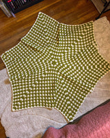 Full view of hexagonal crochet afghan, worked in granny stitch in cream and chartreuse green.   thumbnail