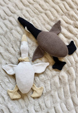 Canada Goose toy lays next to the original Silly Goose in cream and yellow. Both geese have floppy feet and wings, and a stuffed head, neck, and body.  thumbnail