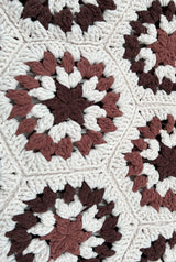Close up of hexagonal crochet motif, worked in cream, dark brown, and medium brown. thumbnail