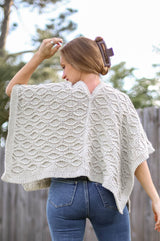 Back view of cabled poncho, showing split back neck and seam down the back.  thumbnail