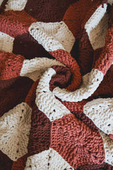 Hexagon motif blanket in cream, tan, and brown, is swirled for a closeup.  thumbnail