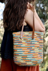 Back view of woman holding crochet tote bag over her shoulder.  thumbnail