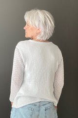 Back view of knit long sleeve tee, showing narrow neckband, solid back, and lace sleeves.  thumbnail