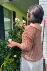 Back view of tan knit top, with vertical lace columns, drop shoulders, and a wide neckline. The top has 3/4 length sleeves. thumbnail
