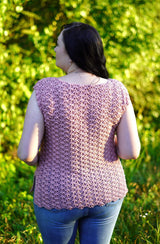 Back view of crochet top in a pale pink. The back has an all-over puff stitch texture.  thumbnail