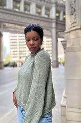 Side view of raglan knit sweater, showing drapey body and sleeve.  thumbnail