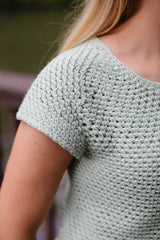 Cropped close up of shoulder on crochet tee, showing raglan increases and short sleeve.  thumbnail