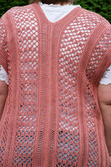 Back view of a lacy cardigan, showing back seam and alternating lace and semi-solid sections.  thumbnail