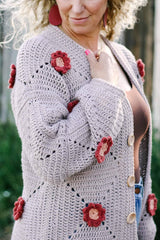 Side view of crochet cardigan, showing individual square construction with flowers at the center of each square. The cardigan has a drop-shoulder construction.  thumbnail