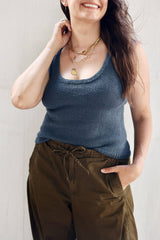 Front view of knit tank top in denim blue, worn with dark olive pants. It has a scooped neckline.  thumbnail