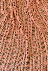 View of crochet blanket with an open grid design and vertical narrow cables. The blanket is slightly scrunched.  thumbnail