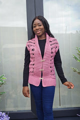 Cropped front view of crochet vest. The vest has wide ribbed front bands help closed with silver fastenings. There is also ribbing at the hem, and open lace pattern on the fronts.  thumbnail