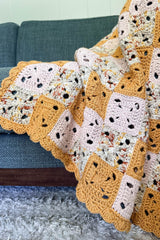 Close up of square motifs in blanket, and scalloped border.  thumbnail