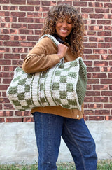 Woman wears crochet bag on her shoulder.  thumbnail