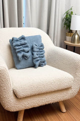 Front view of knit pillow with two offset ruffle appliques.  thumbnail