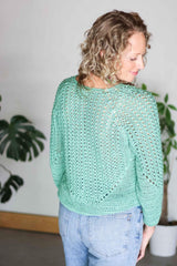 Back view of crochet pullover showing lace pattern and solid hem.  thumbnail