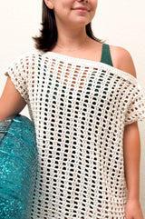 Close up of crochet mesh cover up, showing solid neckband that falls off one shoulder.  thumbnail