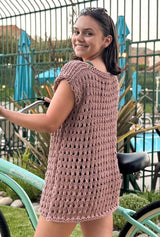 Back view of knit cover-up in a mauve yarn. The cover-up has an open boatneck and falls to upper thigh.  thumbnail
