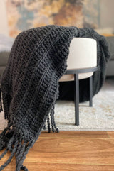 Alternate view of knit throw draped over white side chair, hanging off both sides of chair.  thumbnail