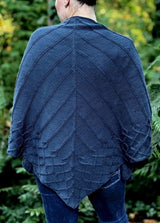 Back view of knit shawl, showing radiating ribs from center spine and lower cabled border.  thumbnail