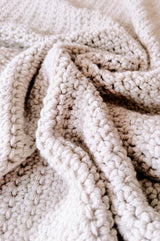 Close up of scrunched crochet blanket, showing stitch detail.  thumbnail