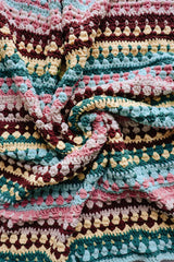 Close up of striped and textured blanket.  thumbnail