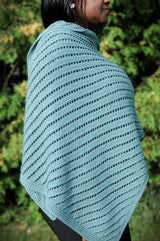 Close up of knit wrap with diagonal lines of eyelets and a garter stitch border.  thumbnail