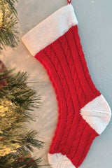 Classic cable stocking in red and white. The cuff heel and toe are white and the leg and foot are red with a cable and rib design.  thumbnail