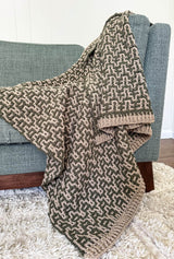 Close up of afghan draped over couch, showing ribbed edgings.  thumbnail