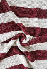 Close up of garter stitch blanket in large stripes of cream and merlot.  thumbnail