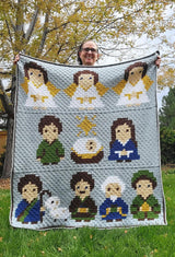 Low angle photo of woman holding crochet afghan toward camera.  thumbnail