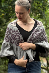 Front view of woman wearing semi-circular shawl wrapped around her shoulders.  thumbnail
