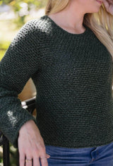 Close up side front view of crochet sweater showing textured stitch pattern on green yarn.  thumbnail