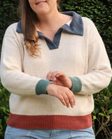 Cropped front view of knit polo sweater, with woman showing off contrast cuffs.  thumbnail