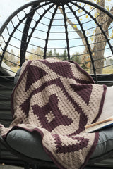 Geometric crochet afghan in seat of hanging chair.  thumbnail