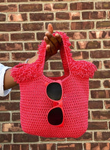  crochet bag in front of a brick wall.  thumbnail