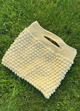 butter yellow crochet bag laying in the grass thumbnail