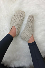 pair of white crocheted Willow slippers worn on feet over a fluffy white rug thumbnail