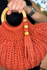 woman holding purse up showing tassle thumbnail