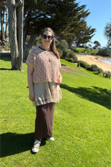 woman wearing a pink crocheted willow top outdoors thumbnail