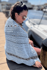 sky blue draped over woman's shoulders from the side thumbnail