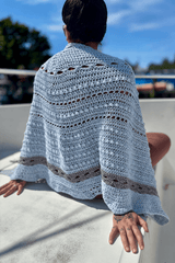 Sky blue shawl draped over woman's shoulders thumbnail