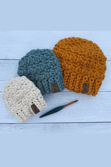 3 sizes of hats with a crochet hook on a wood background thumbnail