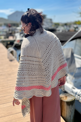 Woman wearing tan and pink shawl on a dock thumbnail