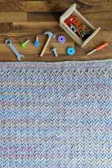 flat lay of blanket with kids toys scattered thumbnail