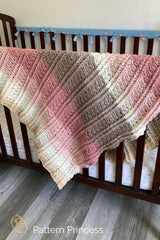 mandala yarn baby blanket on crib thumbnail