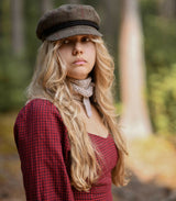 Woman wearing knit scarf in woods thumbnail